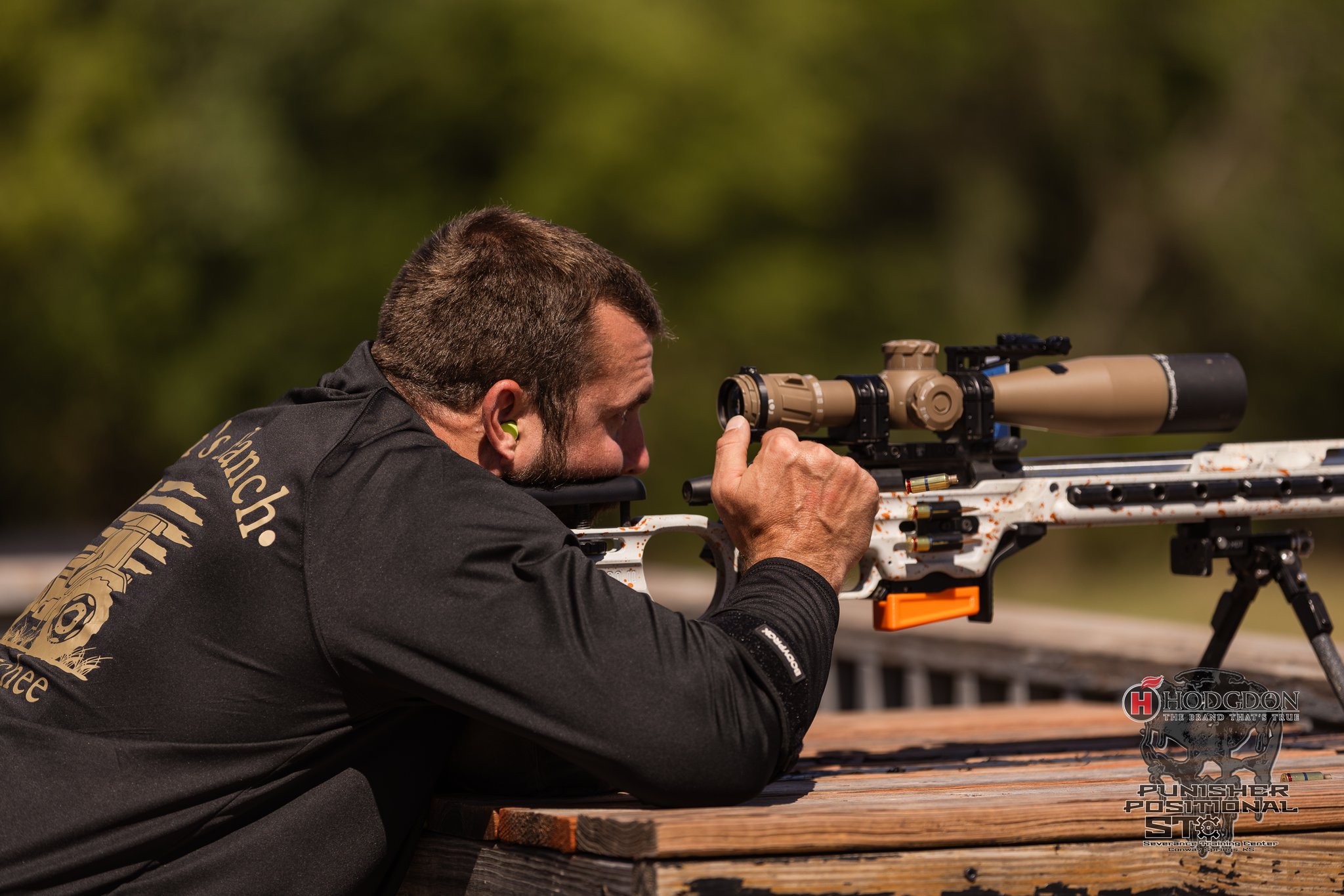 Precision rifle competitor aiming from a supported position